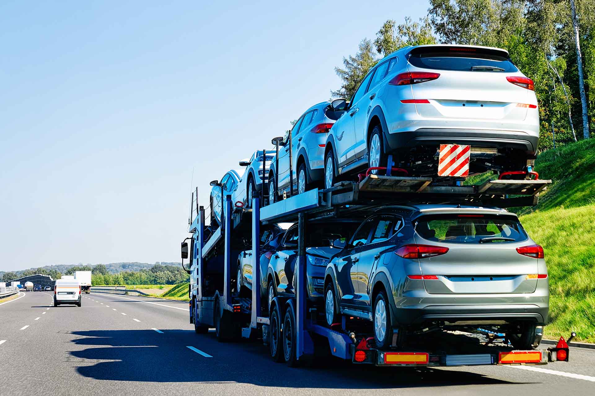 Cars carrier truck on the asphalt road. Truck transporter