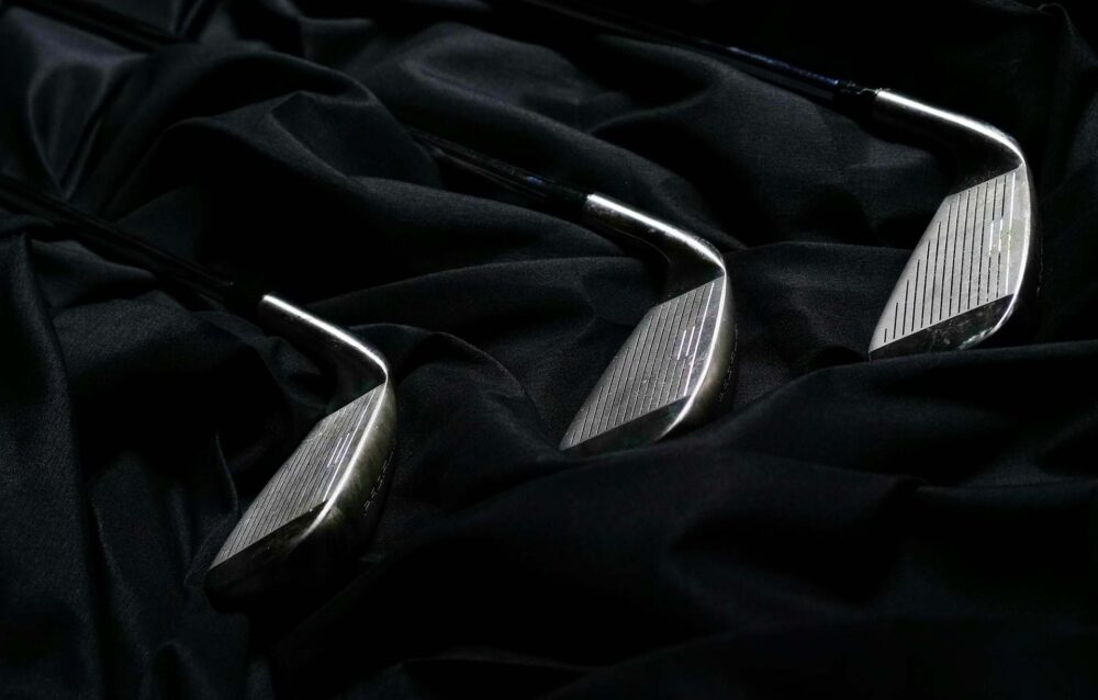 Golf clubs on a black fabric