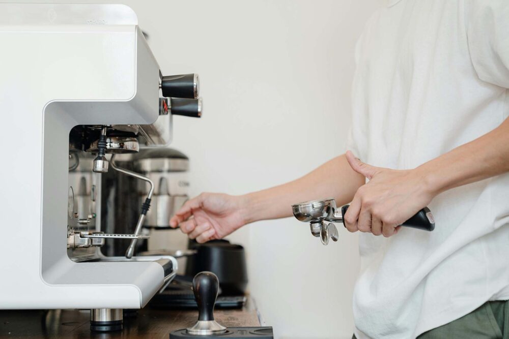 A man using a coffee maker machine