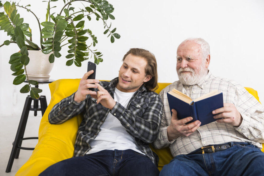 A young man and his father looking at a phone